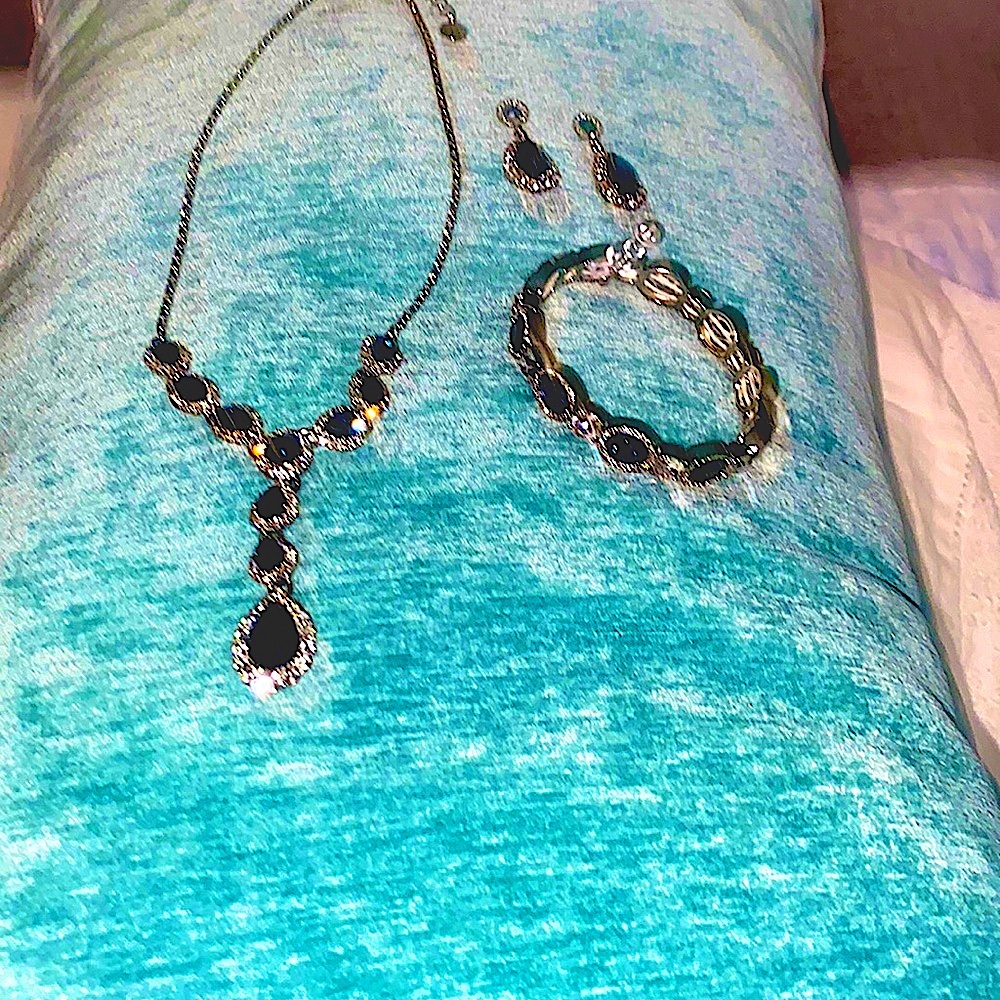 Matching set of faux sapphire gem necklace, bracelet and earrings.